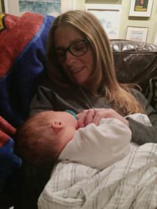grandparent holds grandson beautiful grandmother admires baby